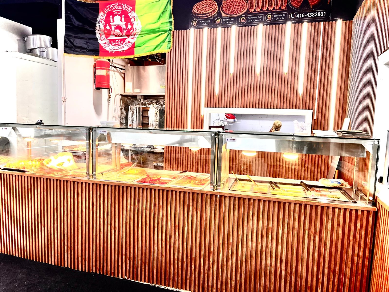Hot food counter beneath the Afghan flag