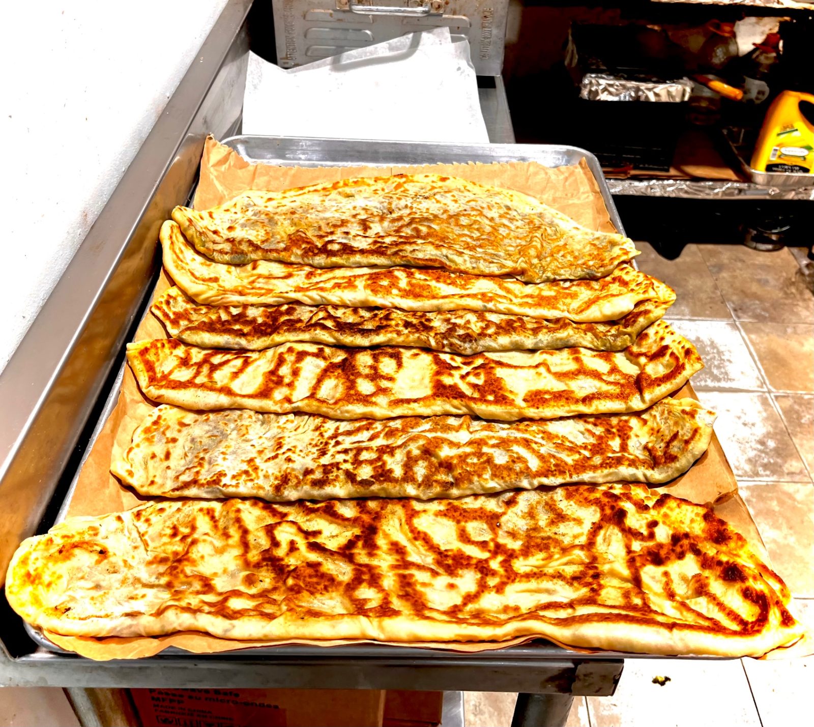 Freshly cooked bolani flatbreads on a tray