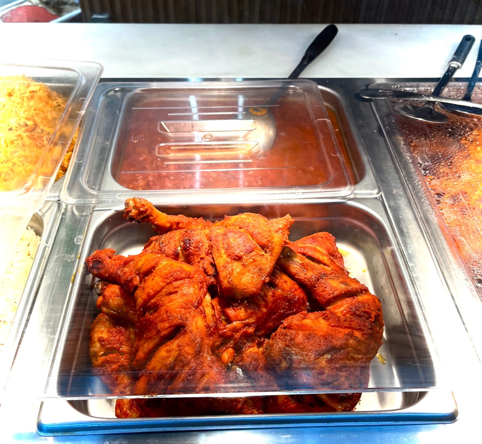 Tandoori chicken legs in the hot food case
