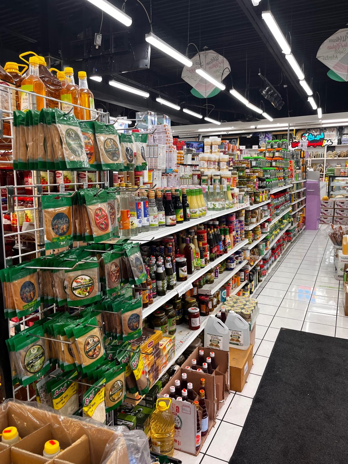 Grocery aisle stocked with spices, sauces and oils